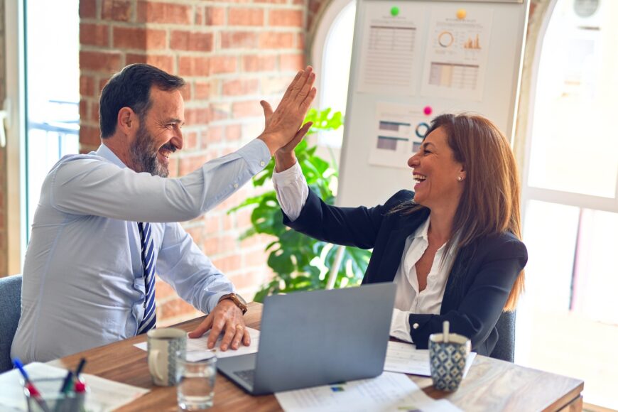 Man & woman happy highfive