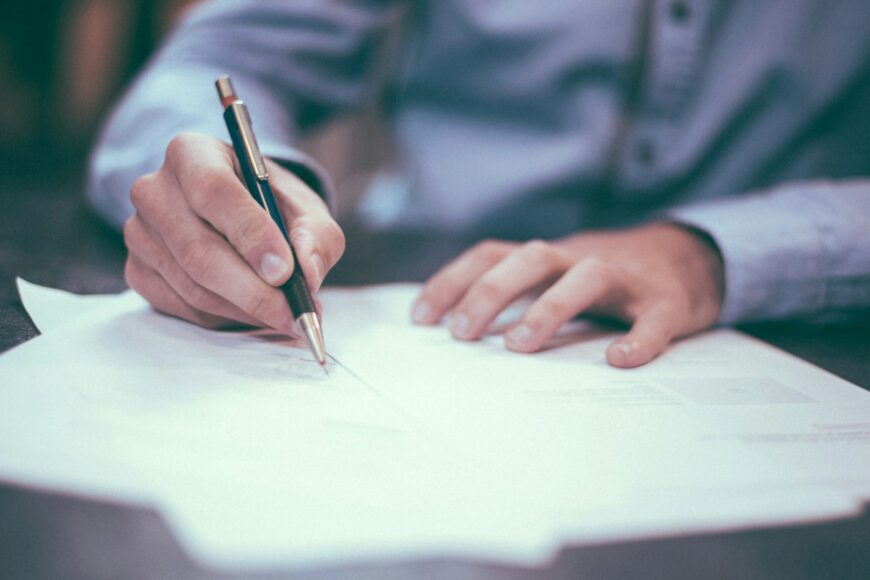 Man signing a set of papers